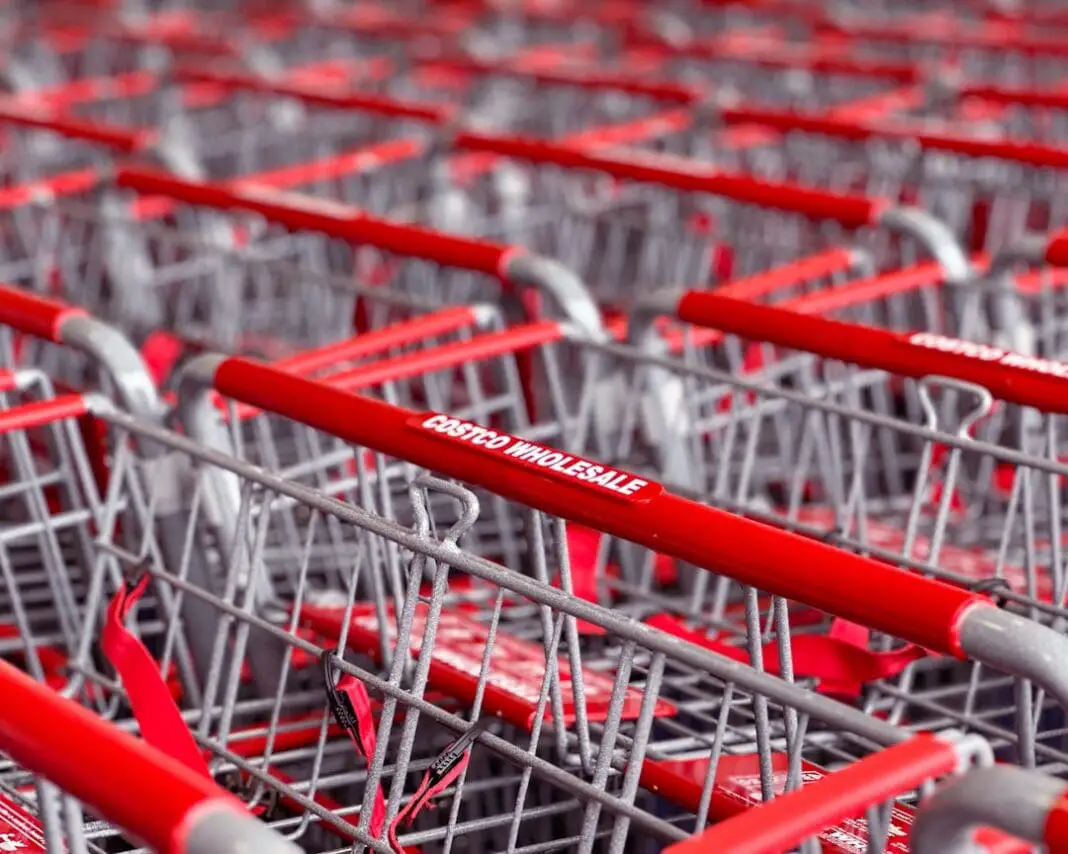 a row of red and silver shopping carts | Photo by gibblesmash asdf on Unsplash