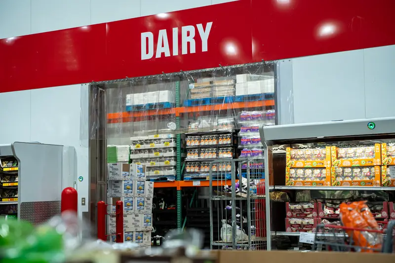 View of Costco dairy section entrance with refrigerated products.
