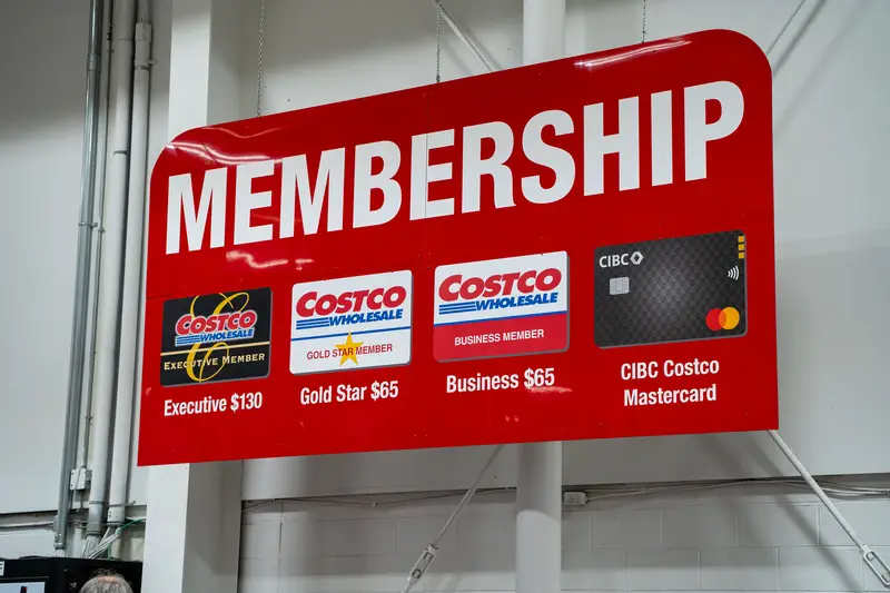 Close up of Costco membership sign displaying card options and prices.
