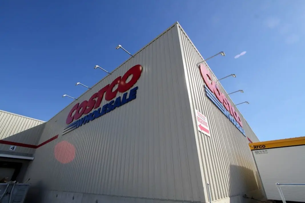 a large white building with a red and blue sign on it