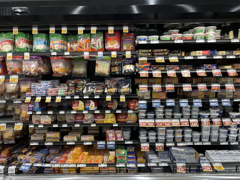 Grocery store Dairy cheese section various varieties and prices