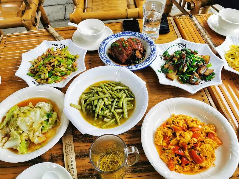 A bamboo table served with traditional Chinese food in a restaurant in China