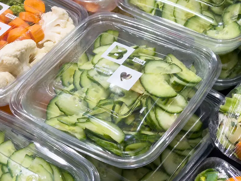 Freshly sliced cucumbers in plastic packaging at grocery store display