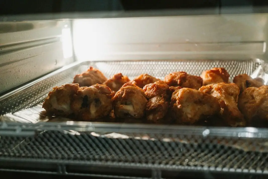 Golden brown pieces of food baking inside an oven